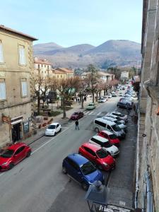 a row of cars parked on a city street at La Finestra sul Corso 3 in Arcidosso