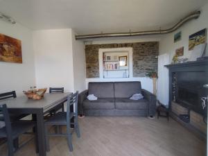 a living room with a couch and a table at Come a casa B&B in Montegrino Valtravaglia