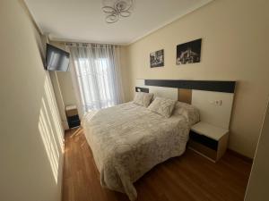 a small bedroom with a bed and a window at Paraiso Spa Reinante in San Miguel de Reinante +10 photos