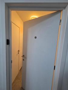 a door leading into a room with a hallway at Flexi flat Gosselies Providence 11 in Charleroi