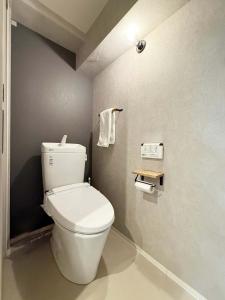 a bathroom with a white toilet in a room at Origaminn 702 by b hotel - 5 mins PeacePark in Hiroshima
