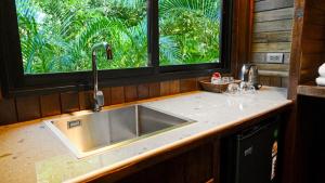 a kitchen counter with a sink and a window at Lush inn Phuket in Ban Suan +205 photos