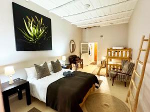 a bedroom with a bed and a living room at Toorwater Spa in Uniondale