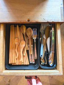 a drawer filled with wooden utensils in a wooden box at とまり木 in Yoshino