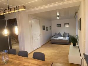 a living room with a bed and a dining table at vitalpha lodge - house in Glarus