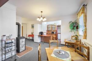 a living room with a table and a kitchen at Pension Katty in Špindlerův Mlýn