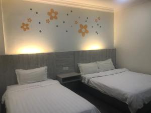 Postel nebo postele na pokoji v ubytování Tambun Inn Hotel