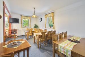 a dining room with wooden tables and chairs at Pension Katty in Špindlerův Mlýn