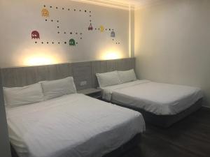 Postel nebo postele na pokoji v ubytování Tambun Inn Hotel