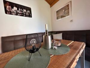 a wooden table with a bottle of wine on it at Jäger-Lodge in Lócs +15 photos