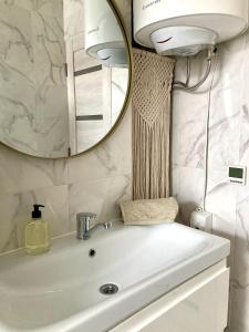 a bathroom with a sink and a mirror at OM East in Aizpute