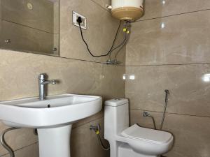 a bathroom with a sink and a toilet at New Amar Palace Shimla with Mountain View in Shimla