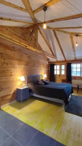 a large bedroom with a large bed in a wooden wall at Smeštaj Iver in Mokra Gora +103 photos