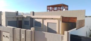 a building with a fence in front of it at Villa RAZAN in Midoun