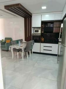 a living room with a table and a kitchen at Villa RAZAN in Midoun
