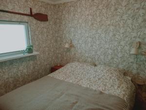 a bedroom with a bed and a window at Het Goudvinkennestje in Matsloot