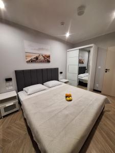 a bedroom with a large bed with oranges on it at Forest Międzyzdroje in Międzyzdroje