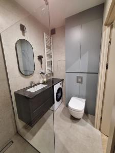 a bathroom with a sink and a toilet at Forest Międzyzdroje in Międzyzdroje +10 photos