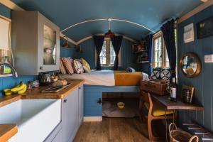 a bedroom with a bed in a room with blue walls at Peace in Piece in Redruth