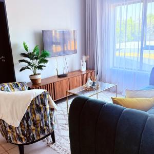 a living room with a couch and a tv at Kurhula nest in Midrand