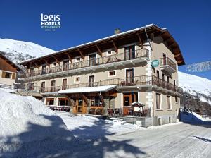 a large building on a snow covered mountain at Hôtel du Crêt Rond in Valloire