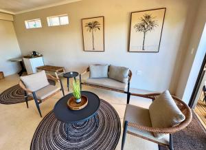 a living room with palm trees on the wall at Toorwater Spa in Uniondale