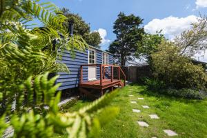 a blue house with a porch in a yard at Peace in Piece in Redruth +17 photos