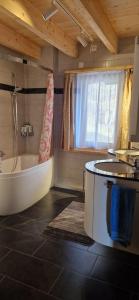 a large bathroom with a tub and a sink at Chalet Wildi Horu OG in Niedergesteln +34 photos