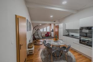 a kitchen and living room with a table and chairs at Apartman Draga in Varaždin