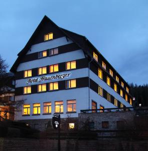 a building with a sign on the side of it at Wagners Hotel im Thüringer Wald in Tabarz