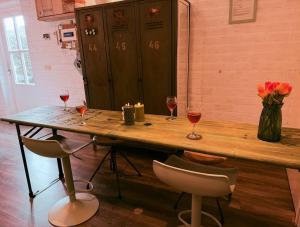 a wooden table with two glasses of wine at Villa Pats in Gilze +112 photos