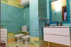 a bathroom with two toilets and a sink and a mirror at Central Blloku 2 bedroom Apartment in Tirana +15 photos