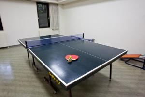 a ping pong table with a ping paddle on it at Shiki Resort Hakone Wanoka in Hakone