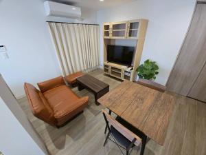 a living room with a couch and a table at Tiz円居 in Minamiawaji
