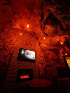a living room with a fireplace and a tv at Villa Gloria in Tourtour