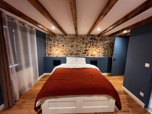 a bedroom with a bed with a red blanket at Villa Gloria in Tourtour