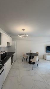 a kitchen with a table and chairs in a room at Appartement luxury in Montpellier +2 photos