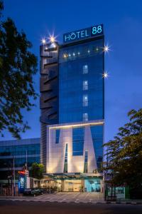 a building with a hotel sign on top of it at Hotel 88 Grogol Jakarta By WH in Jakarta