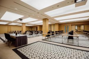 an empty banquet hall with tables and chairs at Radisson Blu Hotel Batumi in Batumi +128 photos