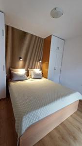 a bedroom with a large bed with white sheets and pillows at Apartments Barbic in Medulin