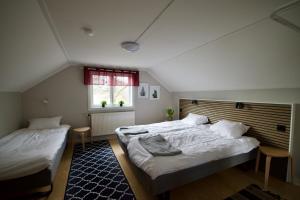 a bedroom with two beds and a window at Hagabergets Vandrarhem in Ullared