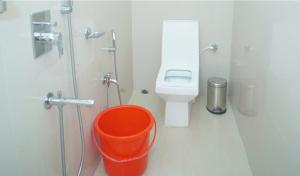 a bathroom with a toilet and a bucket in it at Siddharaj Resort in Mal bazar