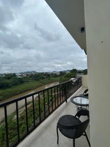 a balcony with tables and chairs and a view of a river at โรงแรมเมืองเลยริเวอร์วิว in Ban Tha Phae +2 photos