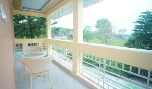 a screened in porch with a table and chairs at Siddharaj Resort in Mal bazar