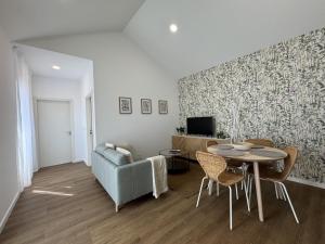 a living room with a table and a couch at Stayin Arrifes I C in Funchal