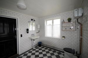 a bathroom with a sink and a toilet and a window at Hagabergets Vandrarhem in Ullared +66 photos