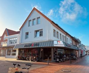 a building with motorcycles parked in front of it at Schmidt-einander W10 in Norderney