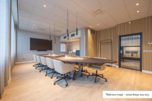 a conference room with a large table and chairs at Postillion Hotel Breda Biesbosch in Raamsdonksveer