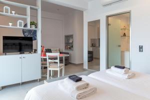 a bedroom with two beds and a living room at Milva Apartments in Kos