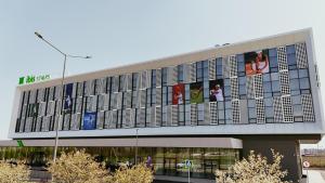 a large building with pictures on the side of it at ibis Styles Chisinau in Chişinău